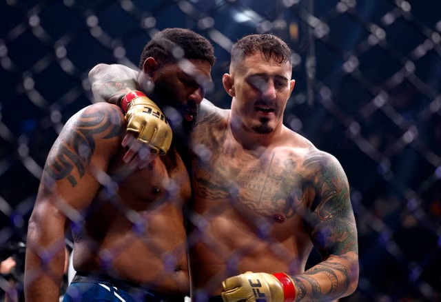 Tom Aspinall (right) co<em></em>nsoles Curtis Blaydes after knocking out the American. PHOTO: REUTERS